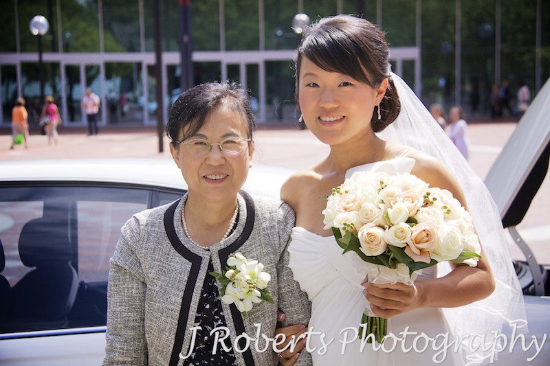 Bride and mother getting out of car at Chinese Gardens - wedding photography sydney